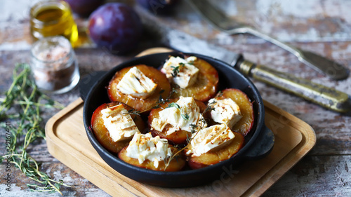 Baked plums with feta cheese. Healthy lunch or snack. Vegetarian food. Selective focus. Macro.