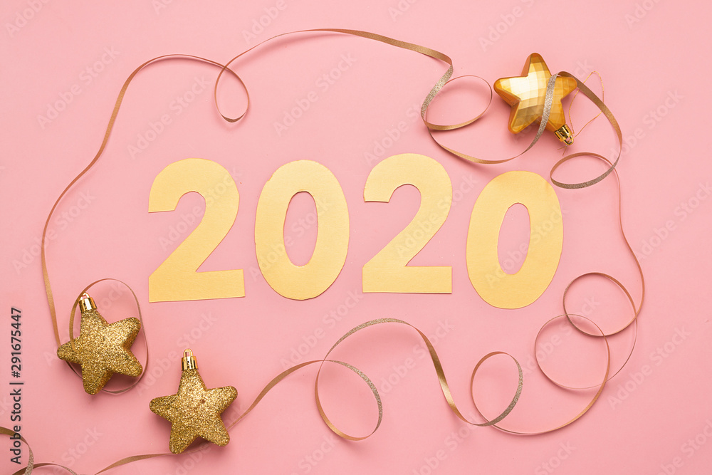 Obraz premium The symbol of the new year, numbers 2020 cut out of gold paper on pink paper background. New Year or Christmas concept.