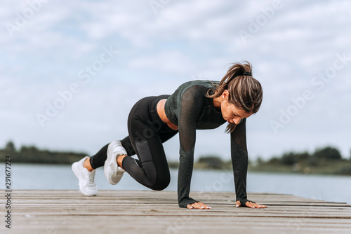 Fit woman exercising by the river.