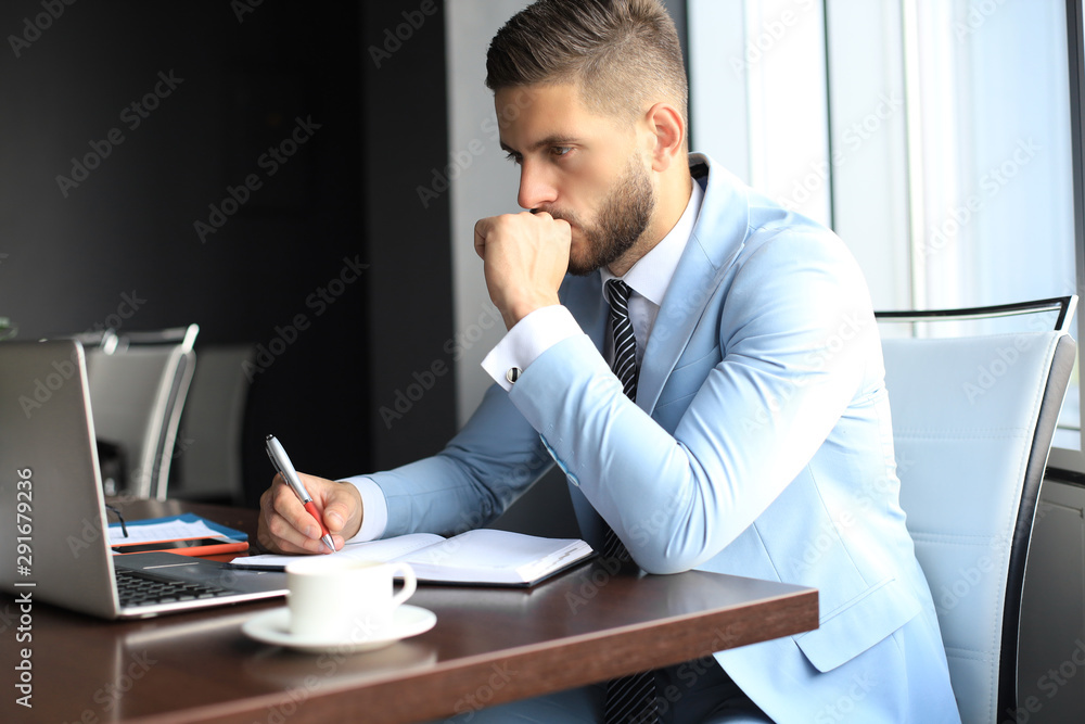 Modern businessman thinking about something while sitting in the office