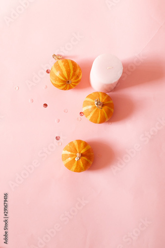 Wallpaper Mural Halloween composition of pink candles, small pumpkins and glitter decor over pink background. Top view, place for text. Torontodigital.ca