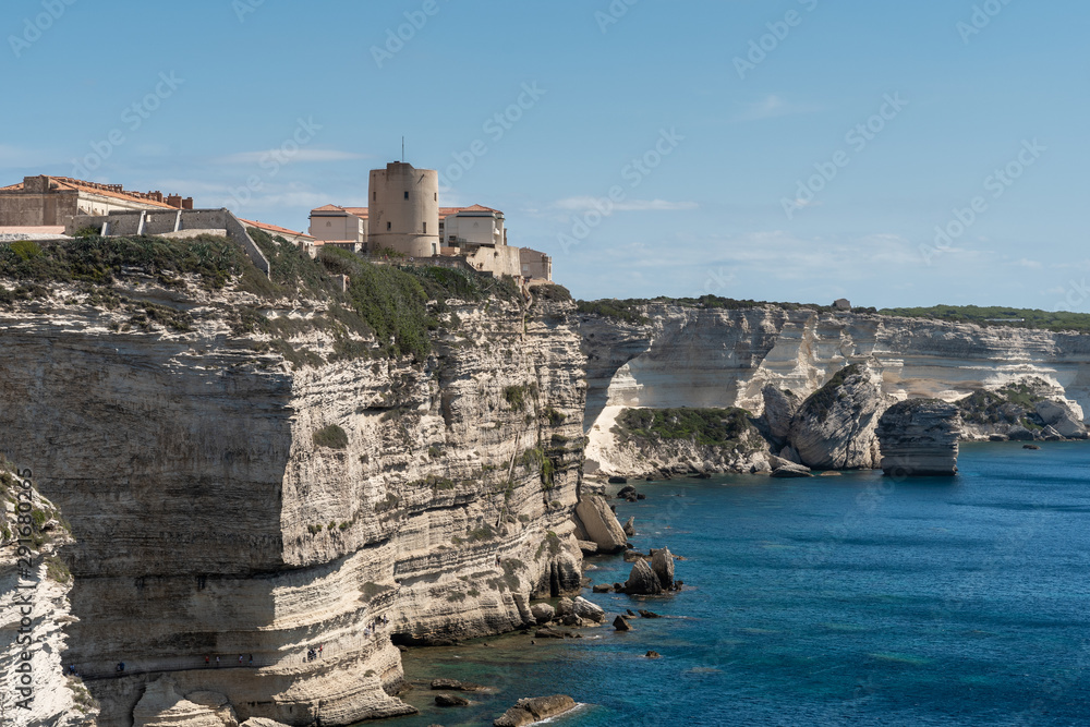 Panoramic view of the high vertical cliffs and the sea. On the rock ancient tower and houses