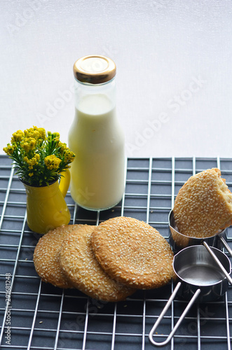 A bottle of milk and low calories sesame biscuits : healthy lifestyle concept (selective focus image)