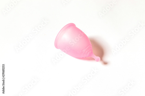 Pink menstrual cup on white background. Flat lay, top view. copy space. Concept female intimate hygiene period products and zero waste.