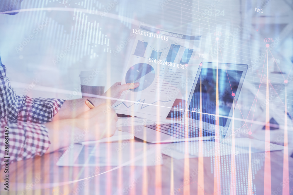 Obraz premium Multi exposure of financial graph with man works in office on background. Concept of analysis.
