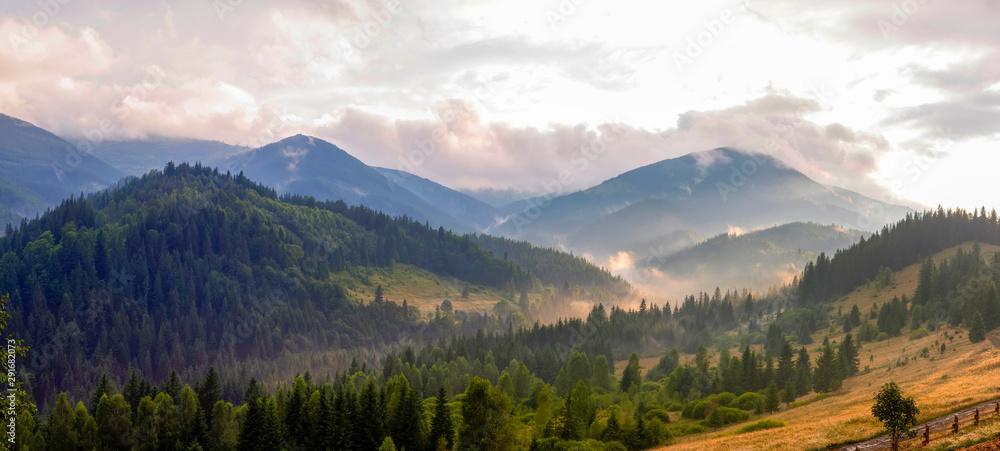 Beautiful mountain landscape with wooded slopes. Summer evening after rain in the Carpathians