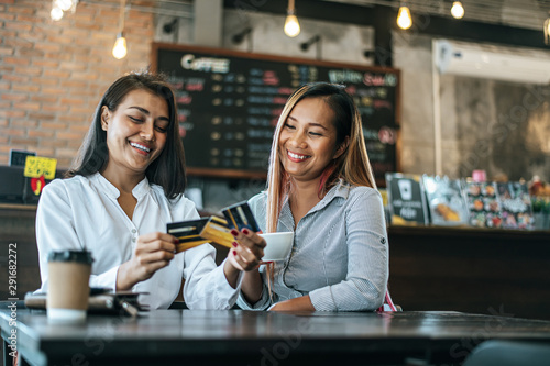 Young women enjoy shopping with credit cards.