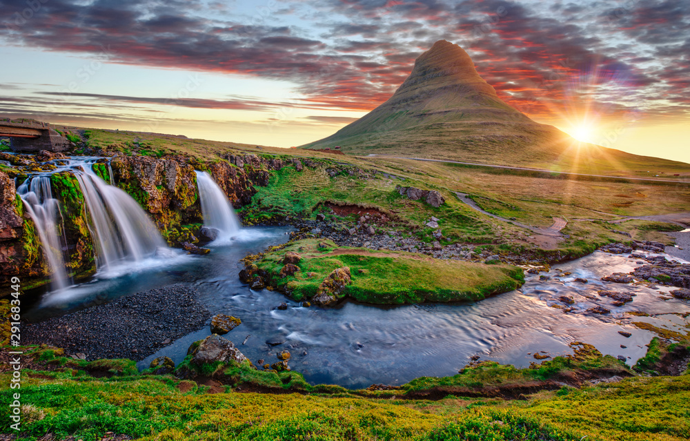 Beautiful landscape with sunrise on Kirkjufellsfoss waterfall and Kirkjufell mountain, Iceland, Europe.
