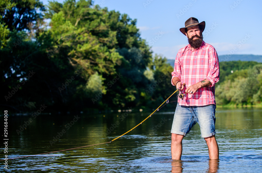 fly fish hobby. Summer fishery activity. fisherman in lake water. hipster fishing with spoon-bait. big game fishing. relax on nature. mature bearded man with fish on rod. He is ready for the fishing fly fish hobby. Summer fishery activity. fisherman in lake water. hipster fishing with spoon-bait. big game fishing. relax on nature. mature bearded man with fish on rod. He is ready for the fishing