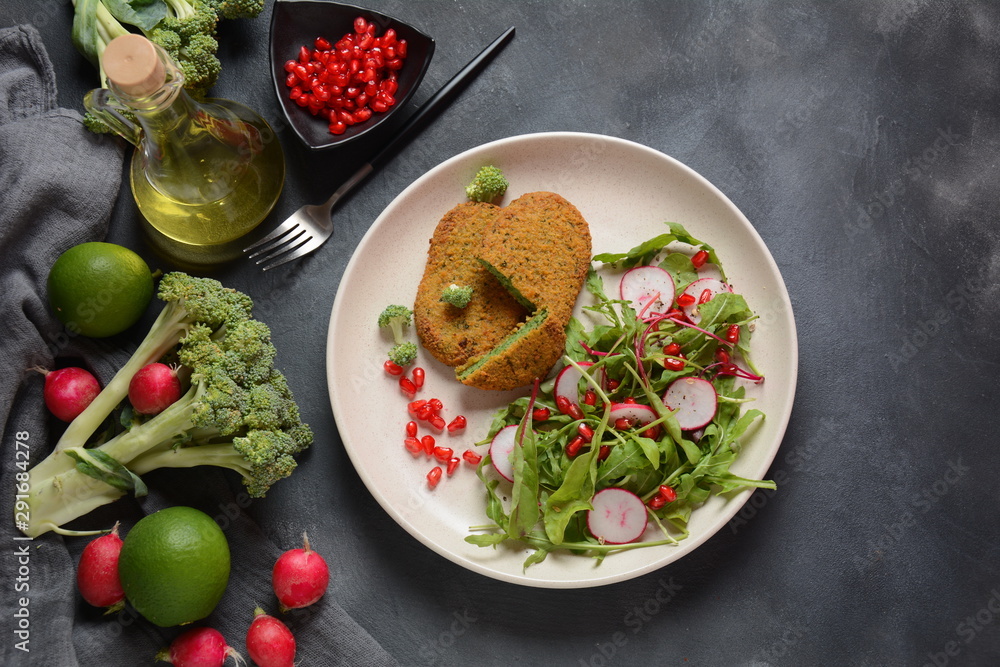 Broccoli schnitzel served with pomegranate salad. Healthy vegan food . Low -fat diet Broccoli schnitzel served with pomegranate salad. Healthy vegan food . Low -fat diet