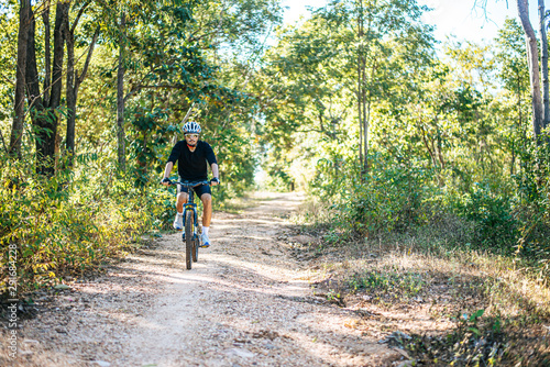 Cyclist Riding the Bike on the Beautiful Spring Mountain Trail © Johnstocker