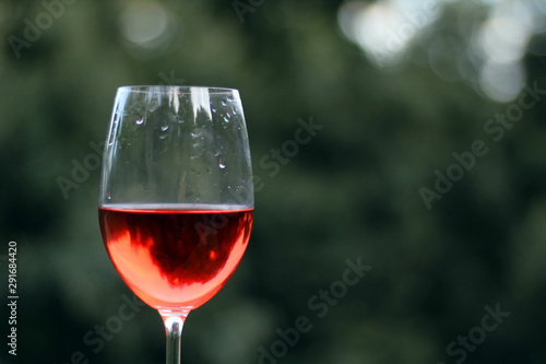 Wineglass with rose wine inside. Copy Space for Text.