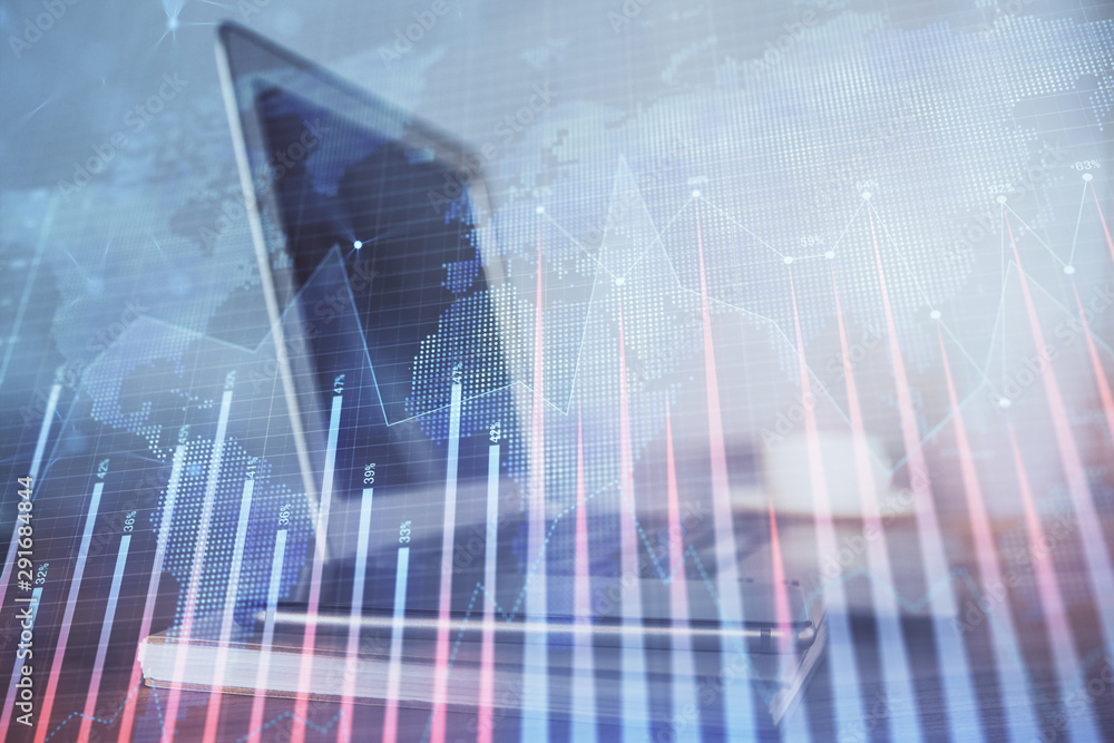 Stock market chart hologram drawn on personal computer background. Double exposure. Concept of investment. Stock market chart hologram drawn on personal computer background. Double exposure. Concept of investment.