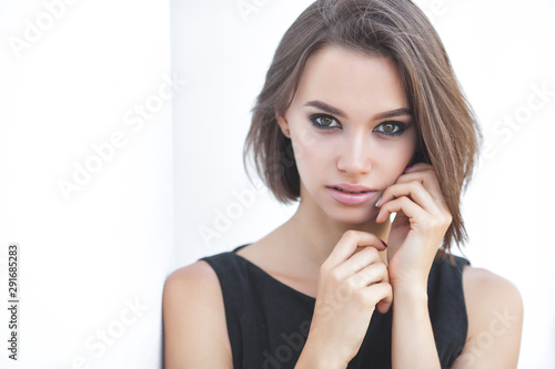Closeup portrait of attractive young woman on neutral background. Beautiful female outdoors.