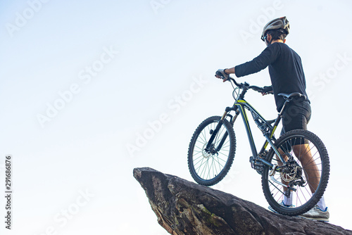 Athletes standing on the mountains with bicycle