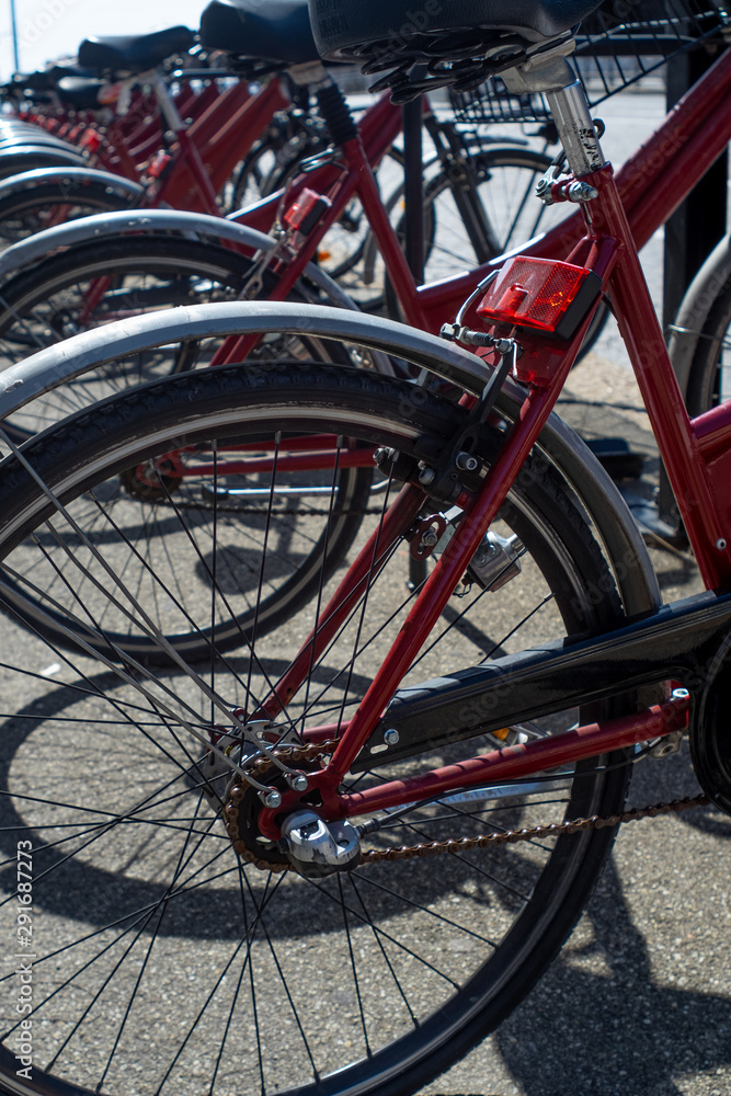 Close-up on public red bicycles in Bologna, Italy.