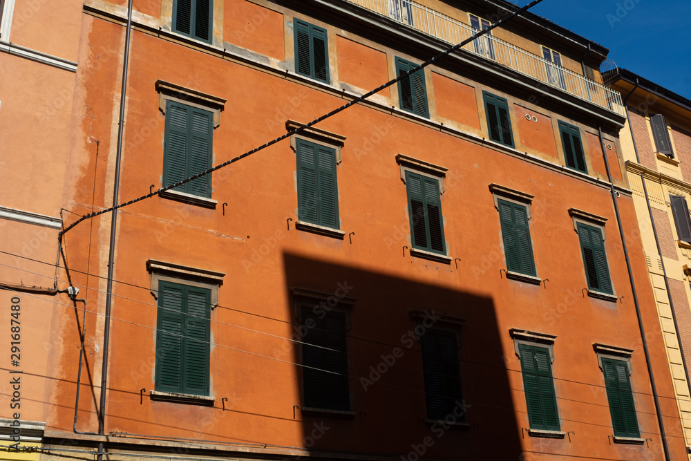 Orange Building in Bologna, Italy with blue sky in the background.