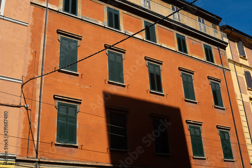 Orange Building in Bologna, Italy with blue sky in the background.