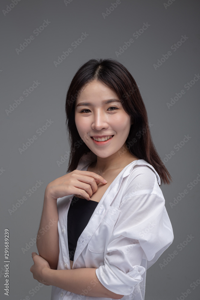 The women wearing a white shirt and hands placed on her chest. The women wearing a white shirt and hands placed on her chest.