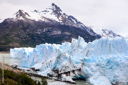 Huge glacier in Patagonia Argentina with snowy mountain on a cloudy day - Perito Moreno 