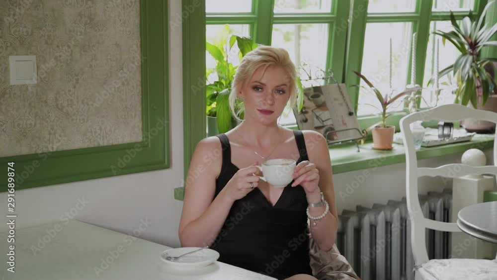 Beautiful young business woman is drinking coffee in a coffee shop. Beautiful young business woman is drinking coffee in a coffee shop.