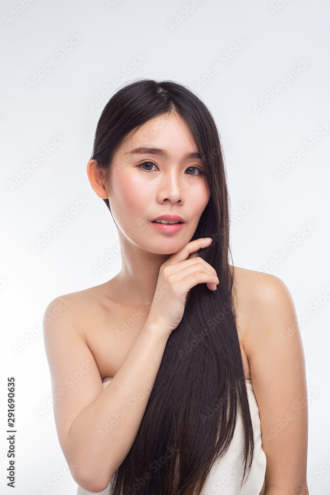 Woman wearing a white strapless dress and hands touching the chin. Woman wearing a white strapless dress and hands touching the chin.