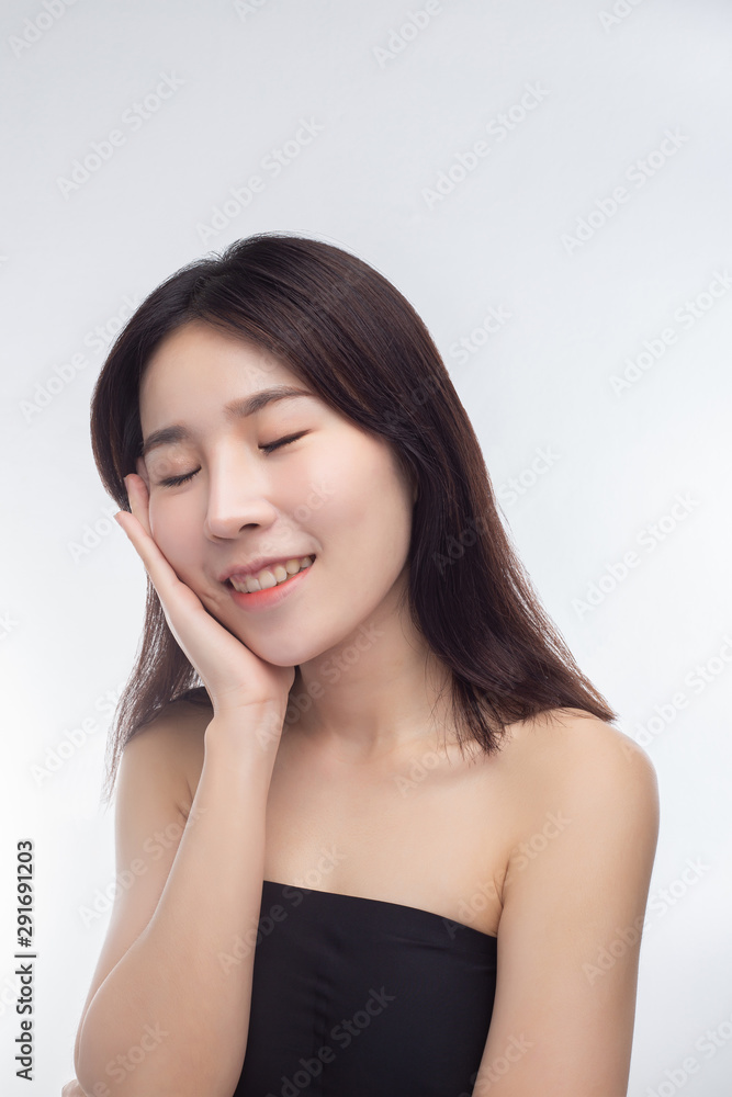 The woman wore a black strapless dress and hands touch her face. The woman wore a black strapless dress and hands touch her face.