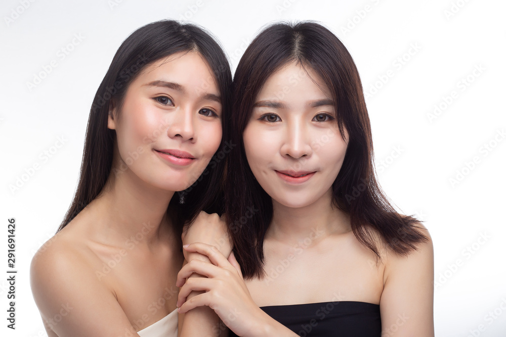 Two young women happily stood together from behind. Two young women happily stood together from behind.