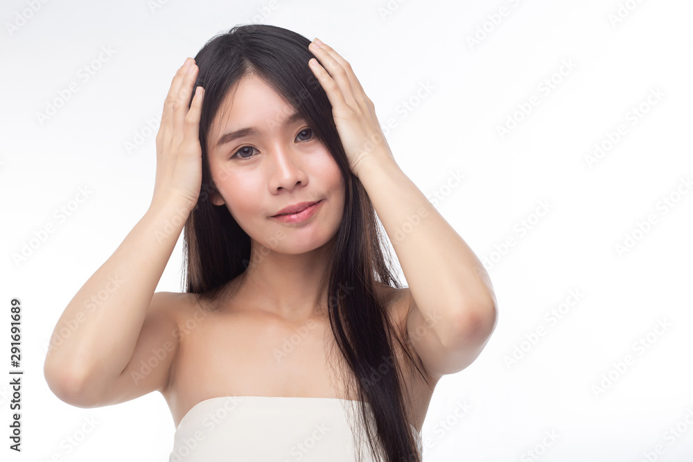 The woman wore a white strapless dress and stood touching her hair. The woman wore a white strapless dress and stood touching her hair.