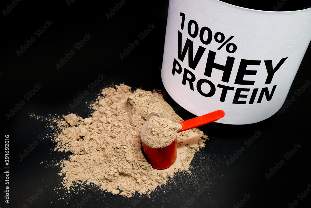 Whey Protein Powder in measuring scoop. Stock Photo