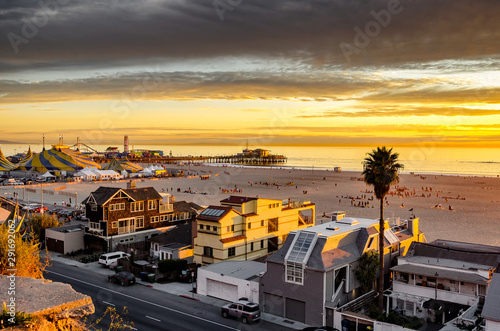 Beautiful sunset on Santa Monica beach, with view of beach homes and famous Santa Monica pier.