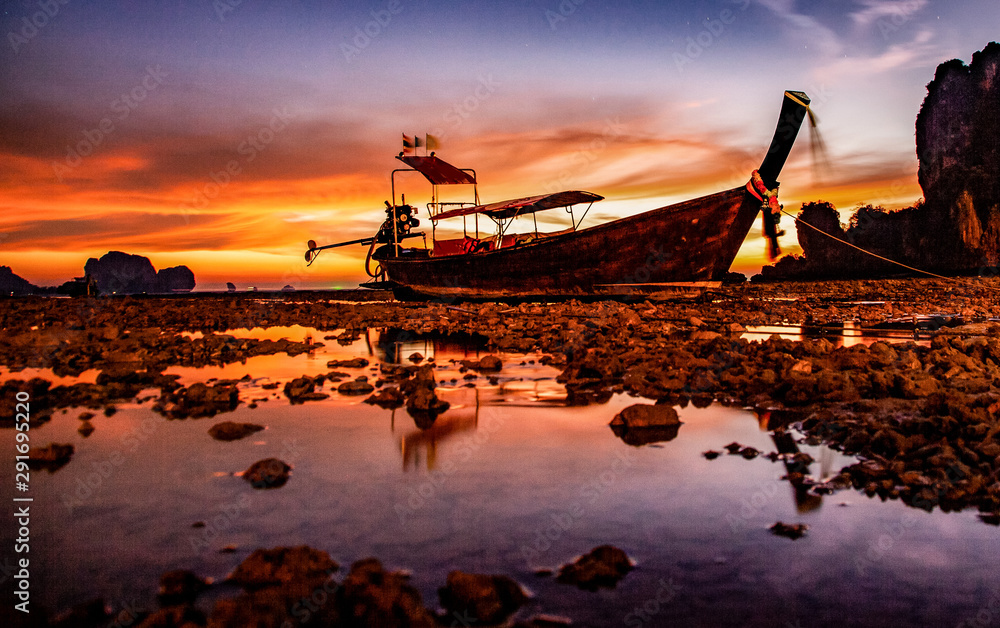 longtail boat and amazing sunset on the beach in Krabi  Thailand