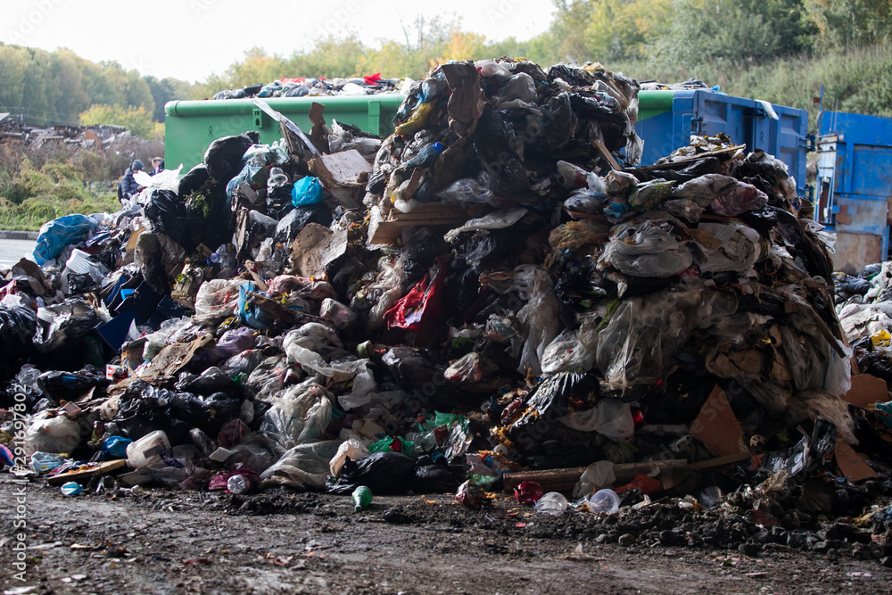 Garbage pile in trash dump or landfill, Waste from household in waste landfill, waste disposal in dumping site, excavator machine is working on a mountain garbage. Garbage pile in trash dump or landfill, Waste from household in waste landfill, waste disposal in dumping site, excavator machine is working on a mountain garbage.