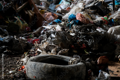  Garbage pile in trash dump or landfill, Waste from household in waste landfill, waste disposal in dumping site, excavator machine is working on a mountain garbage.