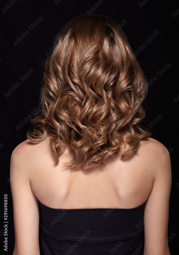 Fototapeta premium Woman from backside with curly hair