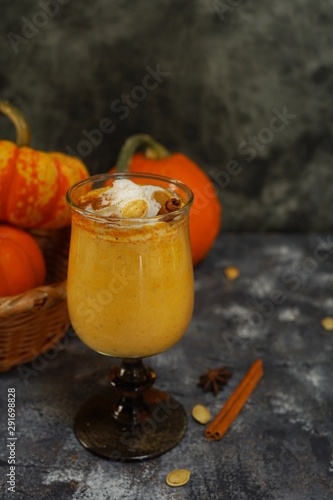 Pumpkin spice latte Smoothie / Pumpkin Spice Latte Smoothie / Fall autumn drink on rustic dark background, selective focus