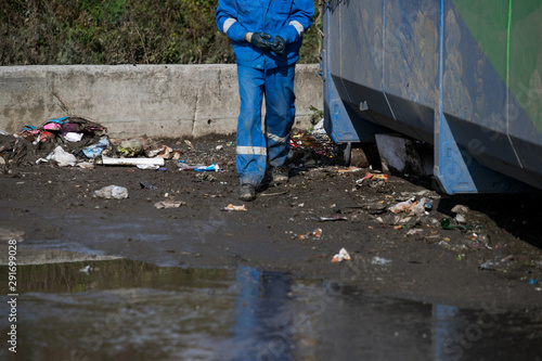 Garbage removal men working for a public utility emptying trash container © Семен Саливанчук