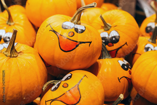 Smiley faces painted on fresh Pumpkins in the Autumn. Halloween photo