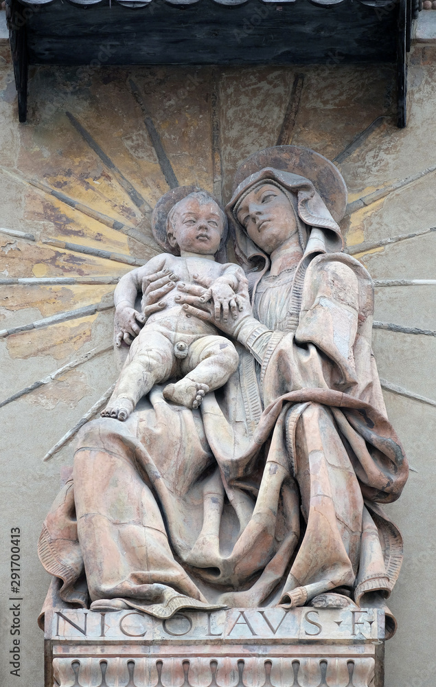 Virgin Nary with baby Jesus statue on house facade in Bologna, Italy