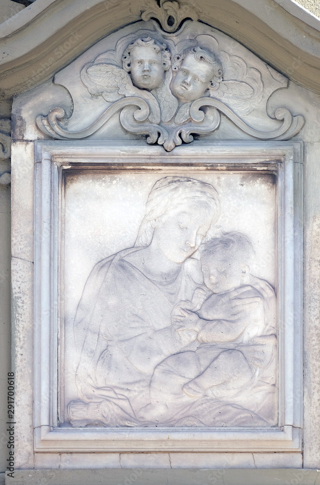 Virgin Mary with baby Jesus, relief on the house facade in Florence, Italy