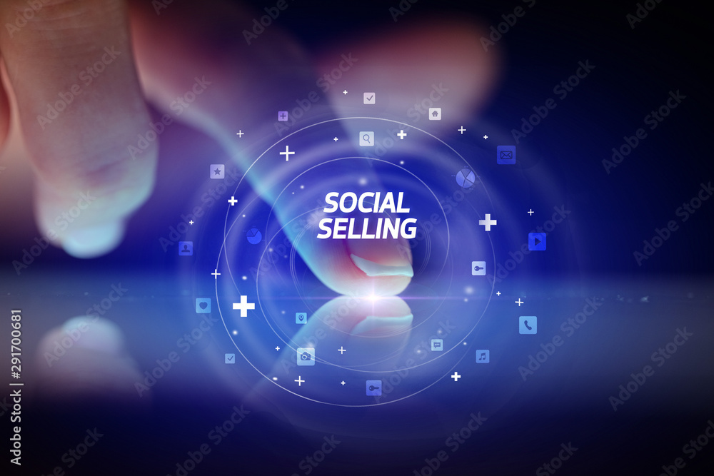 Finger touching tablet with social media icons and SOCIAL SELLING