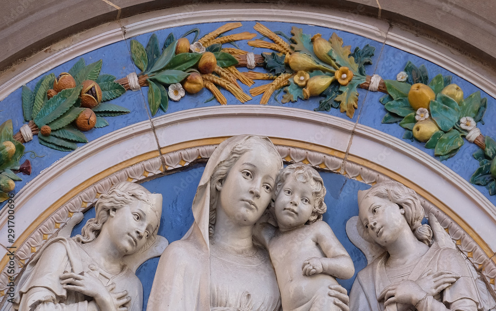 Obraz premium Madonna with Child and Two Angels, lunette by Giovanni Buglioni, above the entrance of the Badia Fiorentina in Florence, Tuscany, Italy