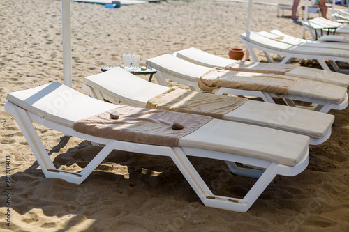 lots of white sun loungers occupied by tourists in the early morning. concept travel