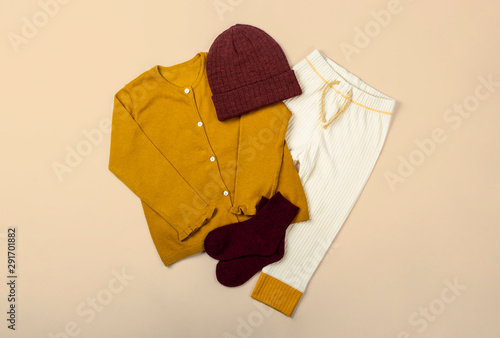 Flat lay of toddler girl autumn and winter clothing on colorful background