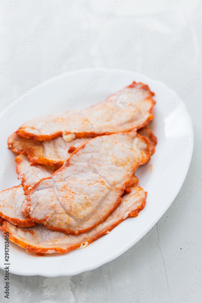 fried meat on white dish on ceramic background