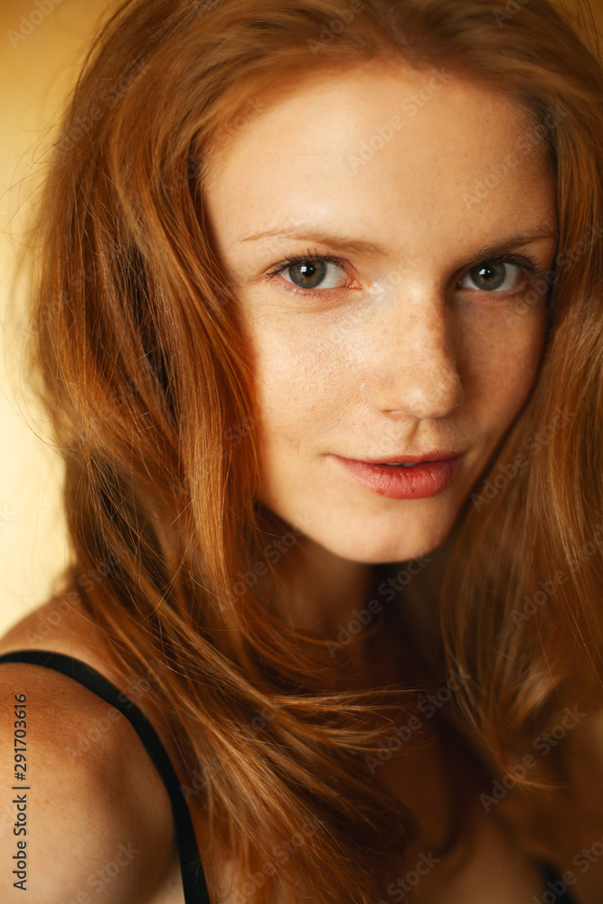 First time concept. Portrait of fashionable model with red (ginger) wavy hair, natural make-up in black lingerie. Perfect skin with freckles. Retro style. Close up. Indoor shot First time concept. Portrait of fashionable model with red (ginger) wavy hair, natural make-up in black lingerie. Perfect skin with freckles. Retro style. Close up. Indoor shot