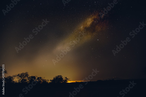 The milky way over the greater kruger with the warm glow of a local community