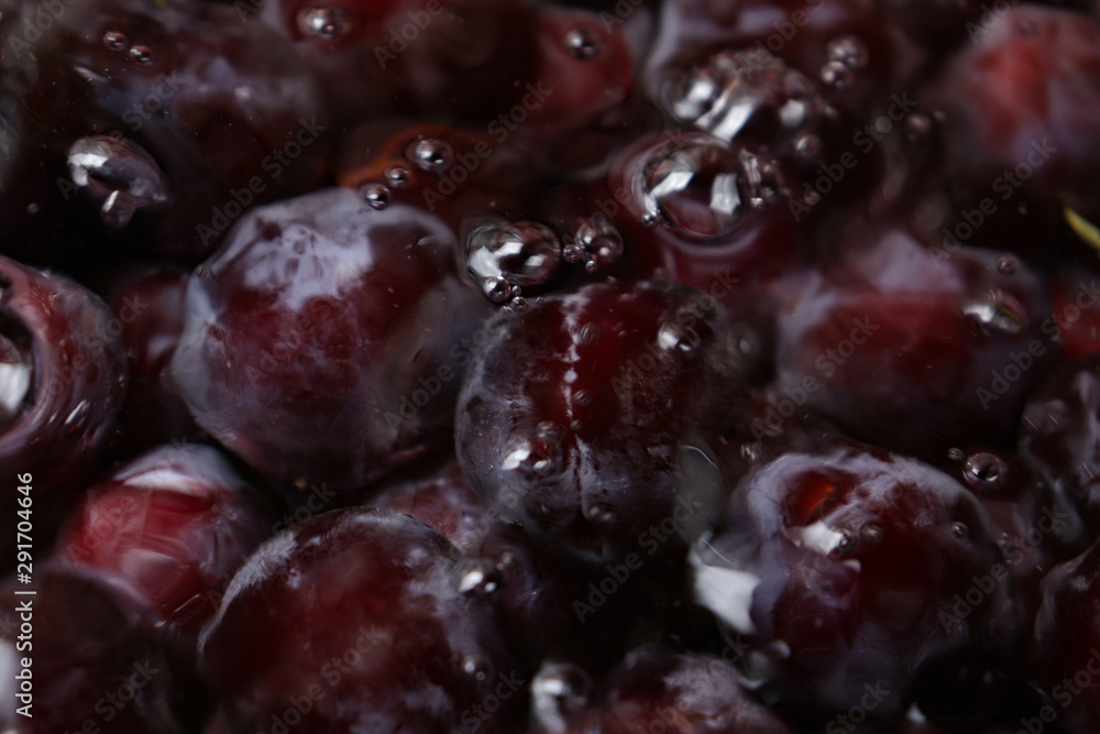 Fresh juicy black plums underwater close-up Fresh juicy black plums underwater close-up