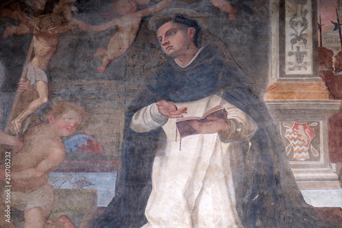 The lunette of one of the side doors depicting St. Thomas Aquinas, detail of the facade of the Church of Santa Maria Novella in Florence, Italy photo