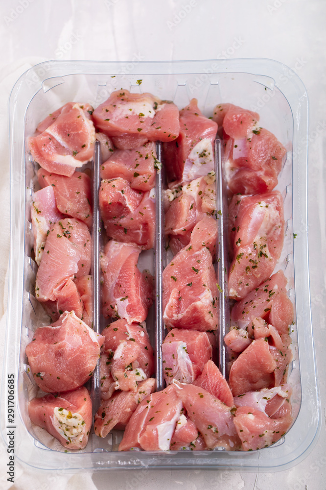 raw meat of turkey with herbs in plastic box